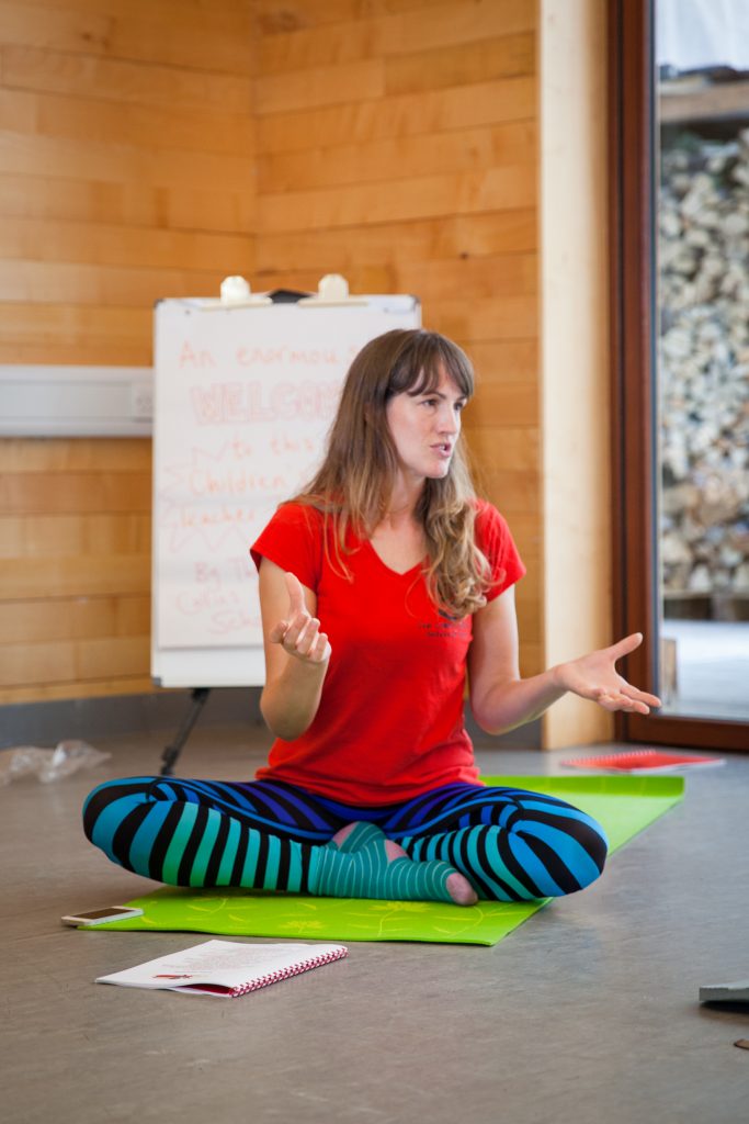 teacher in cross legged pose